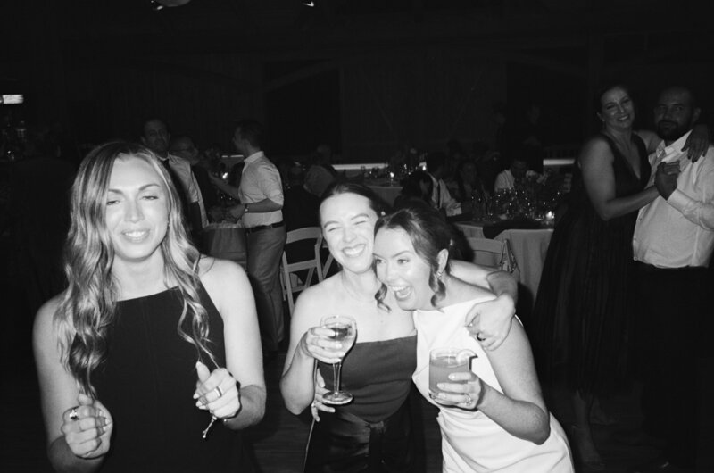 35mm film wedding photo of a bride having a fun time with her friends on the dance floor at Onteora Mountain House