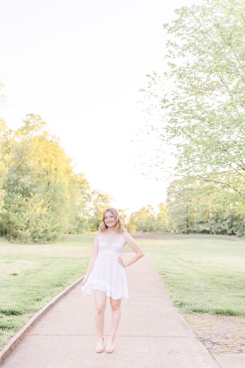 high school girl holding her dress during senior photography in Loudoun County, VA
