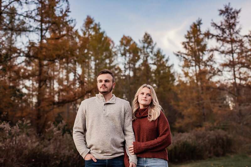 couple outside in woods during fall
