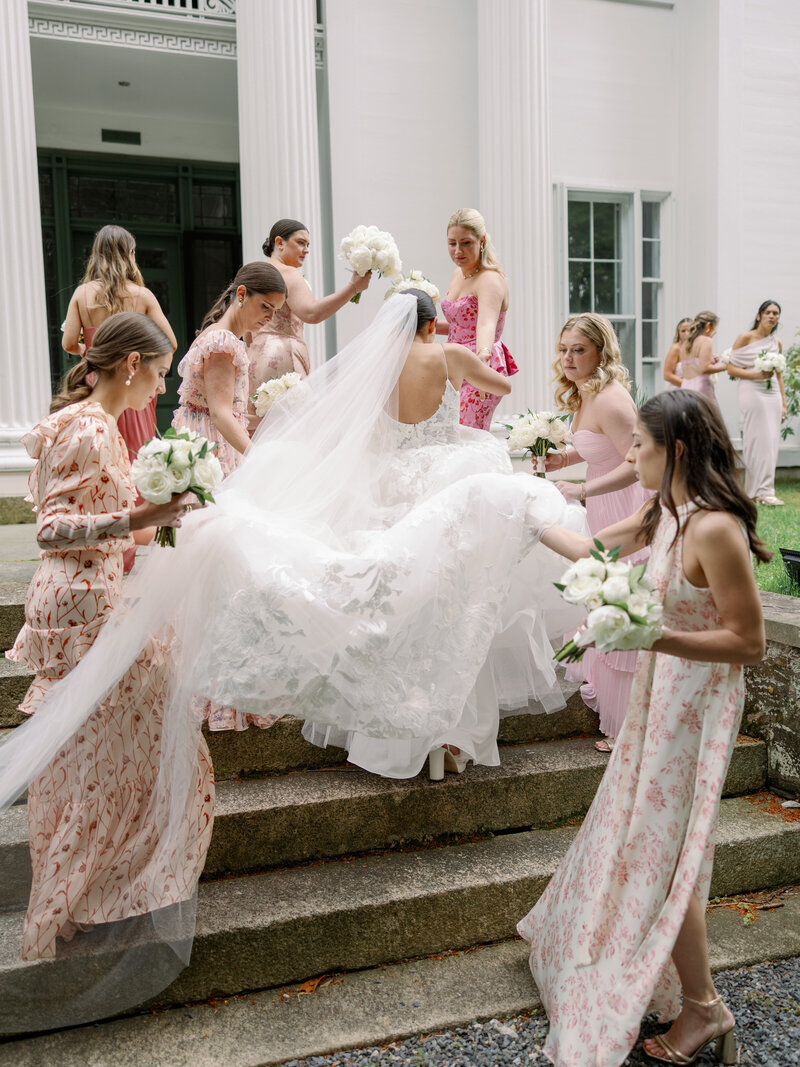 Bride in custom Monique Lhuillier walks with groom at wedding in Miami