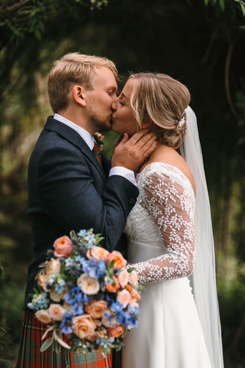 Couple Kiss at their wedding at Hotel Endsleigh