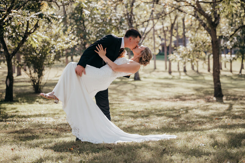 bride and groom hugging while holding bouquet