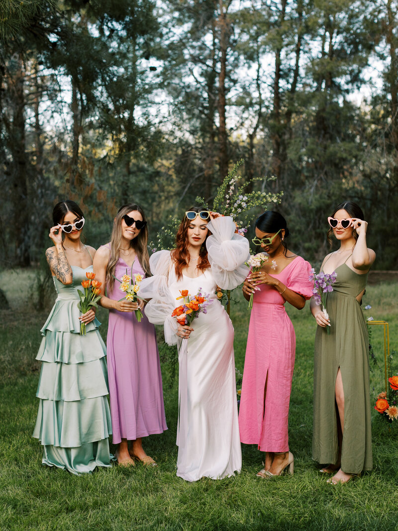 bride and bridesmaids with sunglasses posing