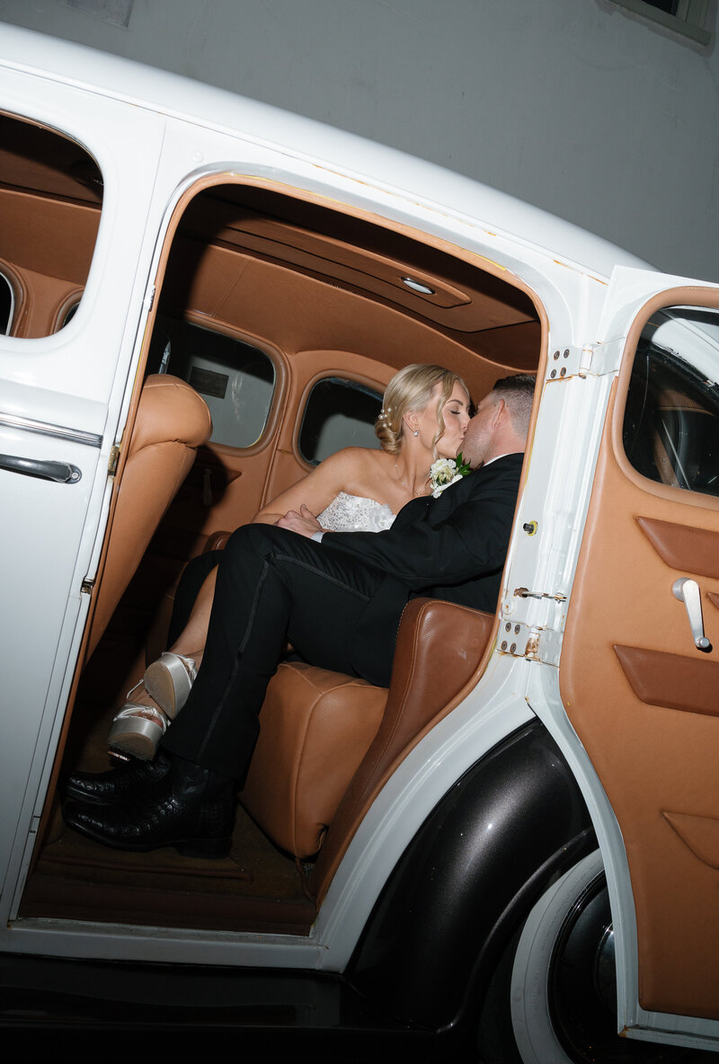 Bride and groom kissing in car taken by east coast photographer Shelby Ann Photos