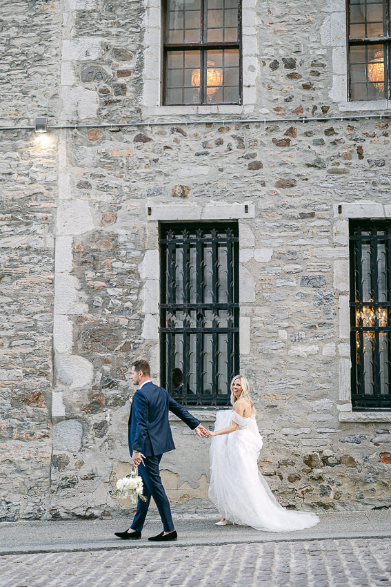 Newlyweds walking in Old Montreal street near Auberge Saint-Gabriel
