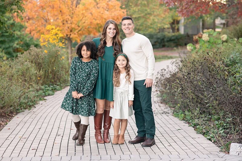 Fall outdoor family photo of family of four wearing shades of green by Maryland Family Photographer