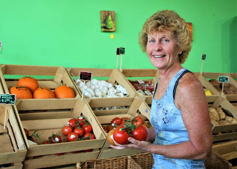 Image of fitness coach holding produce to be fit and healthy