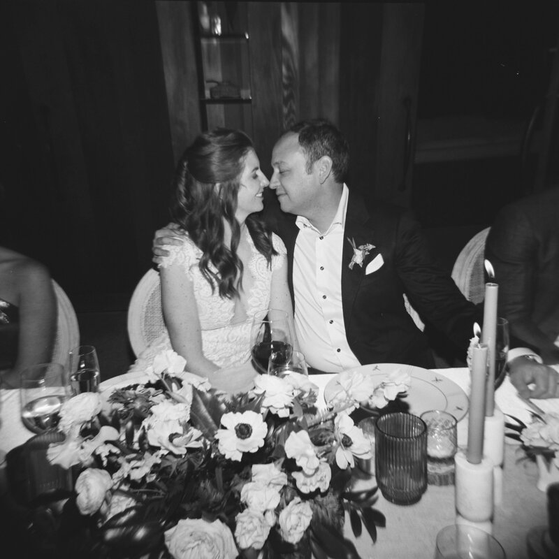 Bride and groom looking at each other smiling