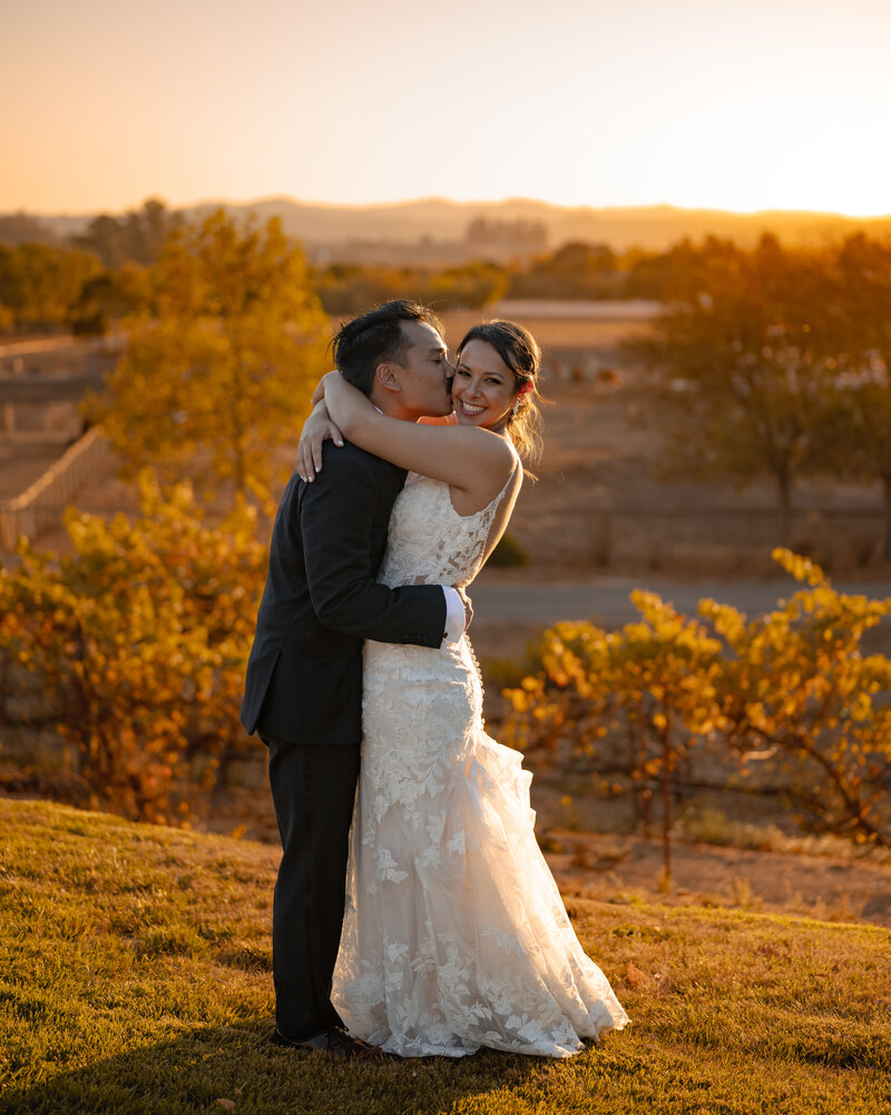 couple kissing under arch