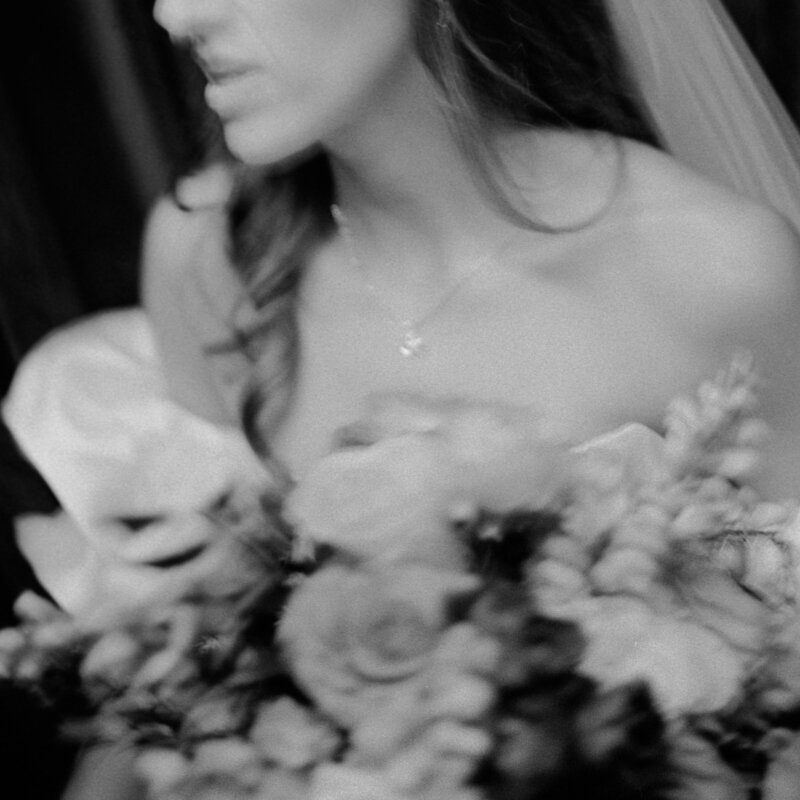 Bride and Groom looking at each other on a couch outside
