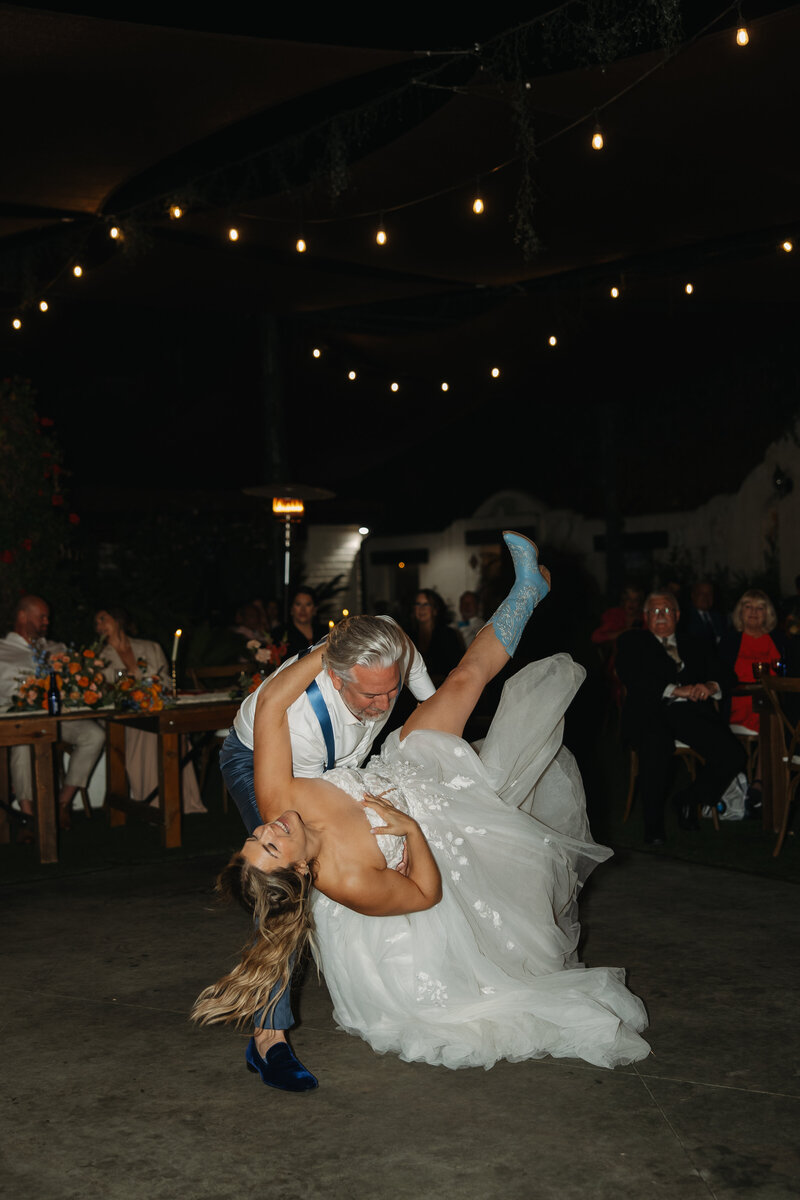 wedding reception, tivoli wedding, cowgirl boots with wedding dress, groom dipping bride
