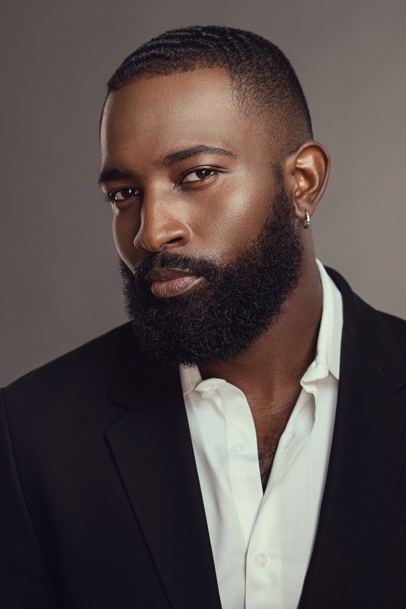 Professional portrait of Dillard in a dark suit, captured with a serious expression by Ylva Erevall.