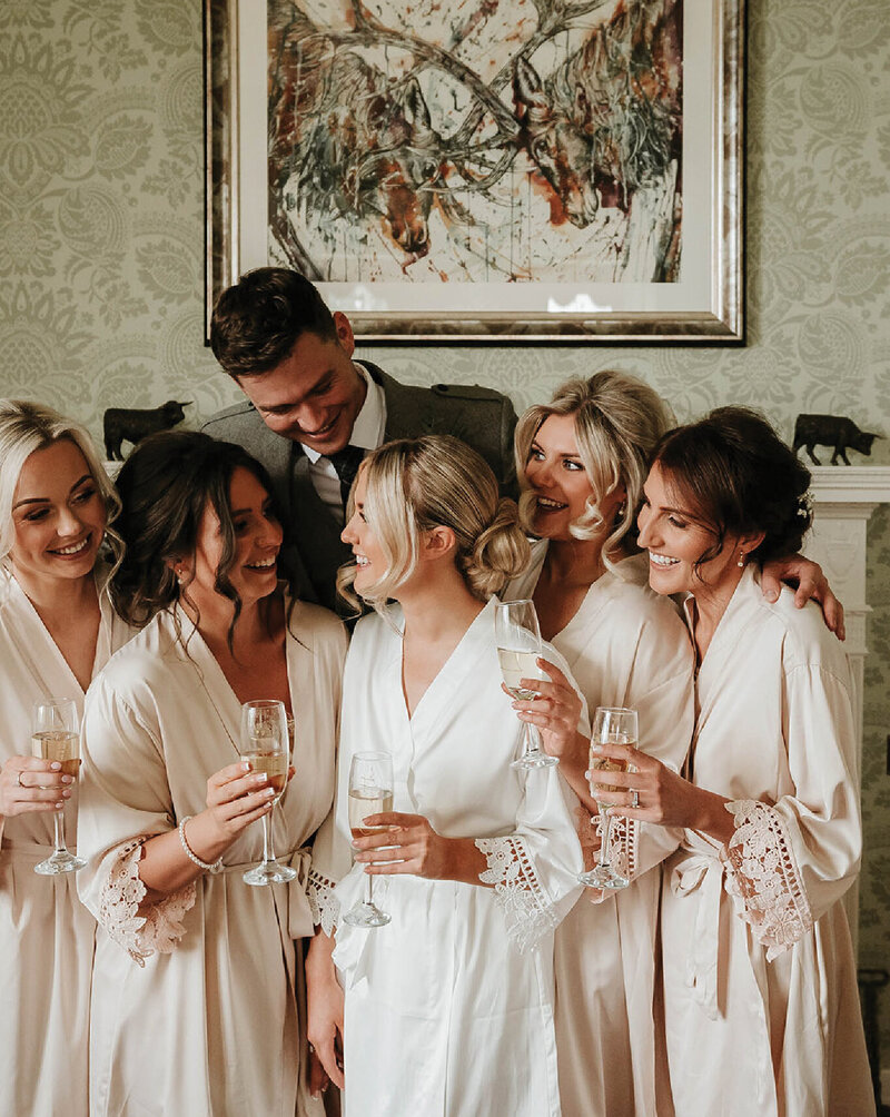 bridal party sharing champagne