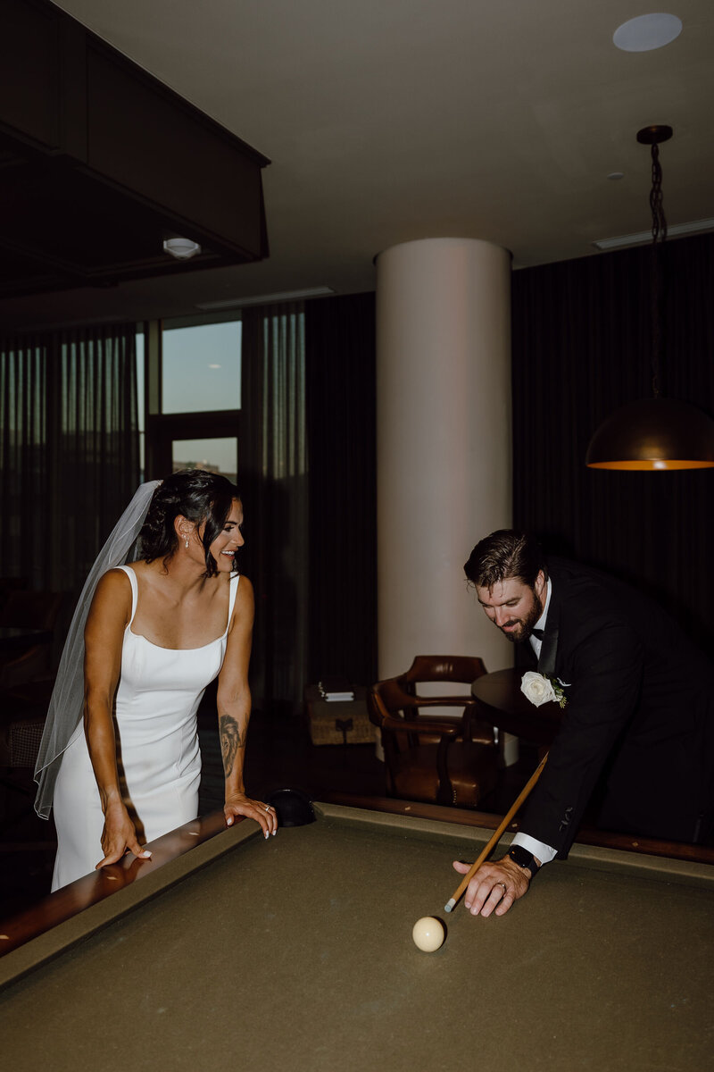 bride and groom shoot pool