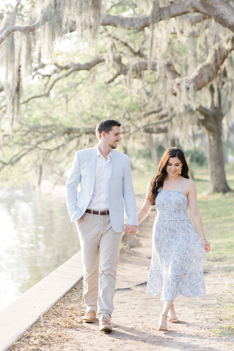 man and woman walking while holding hands