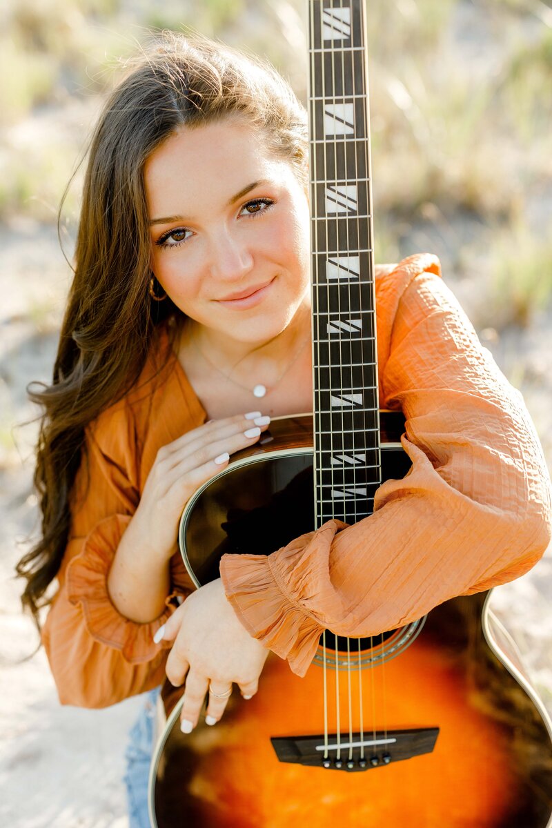 Photo by Massachusetts senior portrait photographer Christina Runnals | Senior pictures of girl holding guitar
