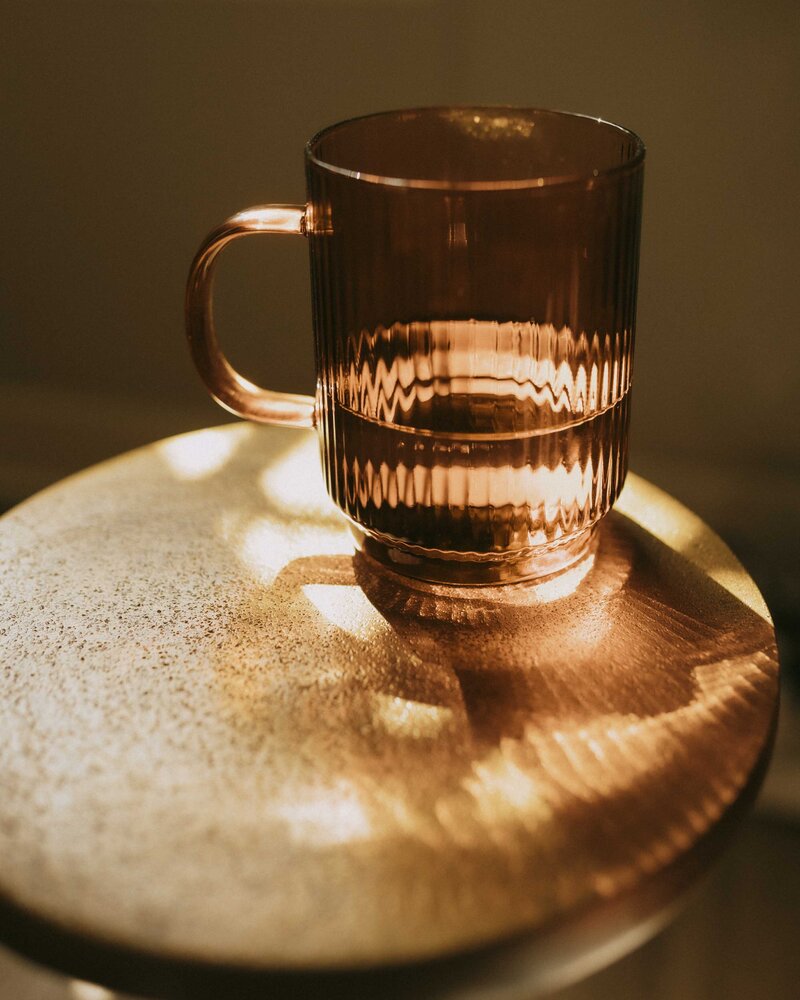Orange glass mug on table