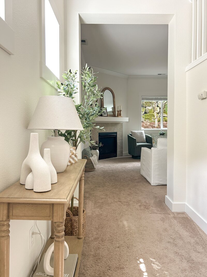 North King County condo foyer styled by Modern Mollusk with traditional wood furnishings and cream decor.