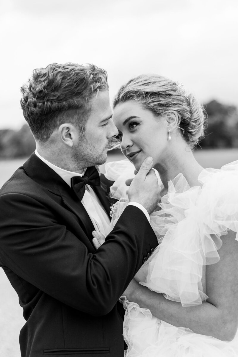 Bride and Groom smile at each other for couples portrait