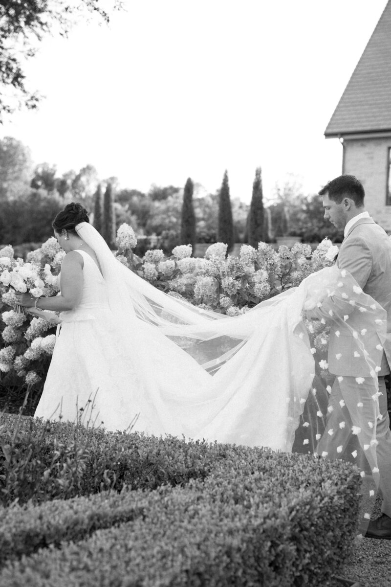 Bride and groom at an Oklahoma estate garden wedding surrounded by hydrangeas, coordinated by Harper Mae Events