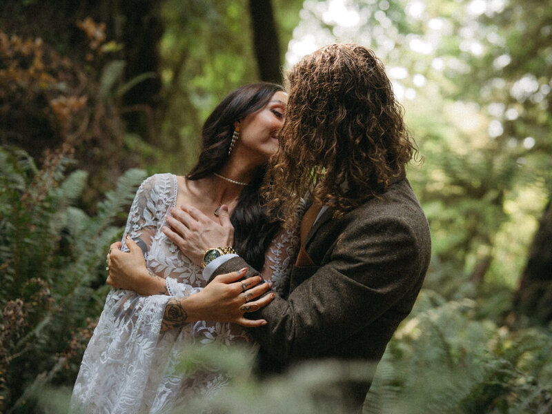 bride and groom hug in redwoods forest
