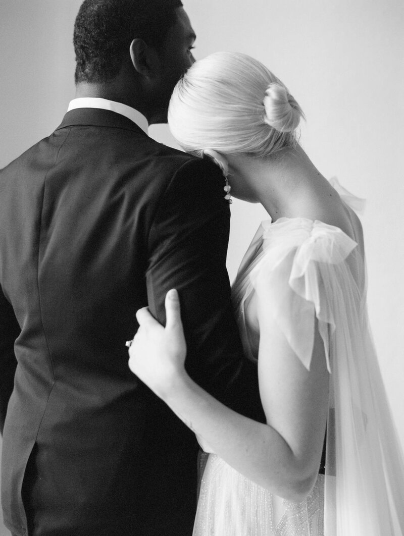 A couple embraces during a still moment on their wedding day