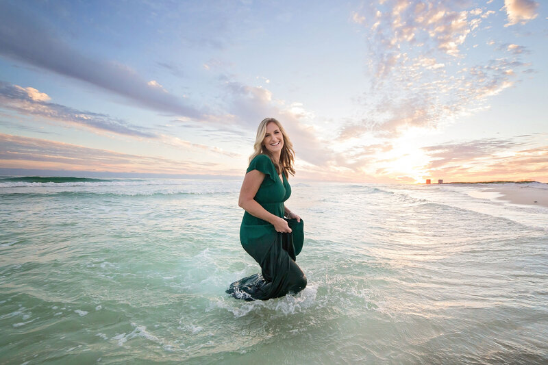 photographer in water at Pensacola Beach at sunset