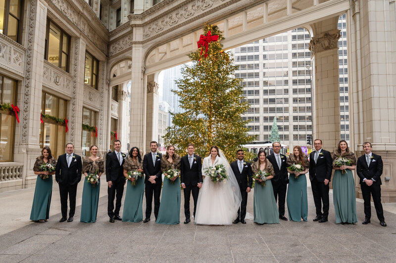 Wedding party line up at the Wrigley Building in winter