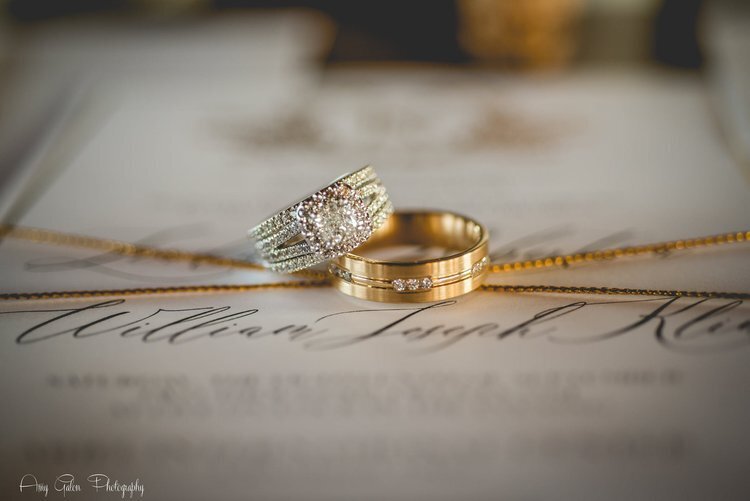 wedding rings on top of invitation