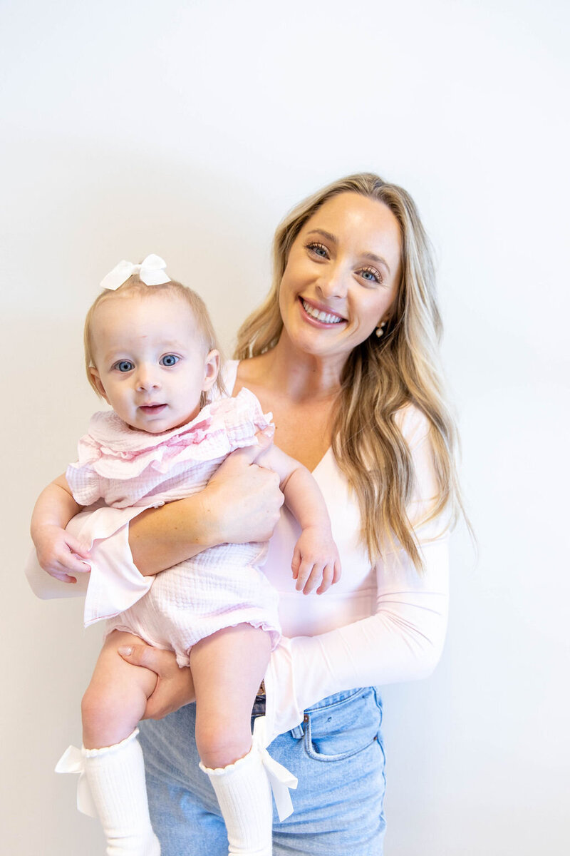 Woman holding her baby, smiling