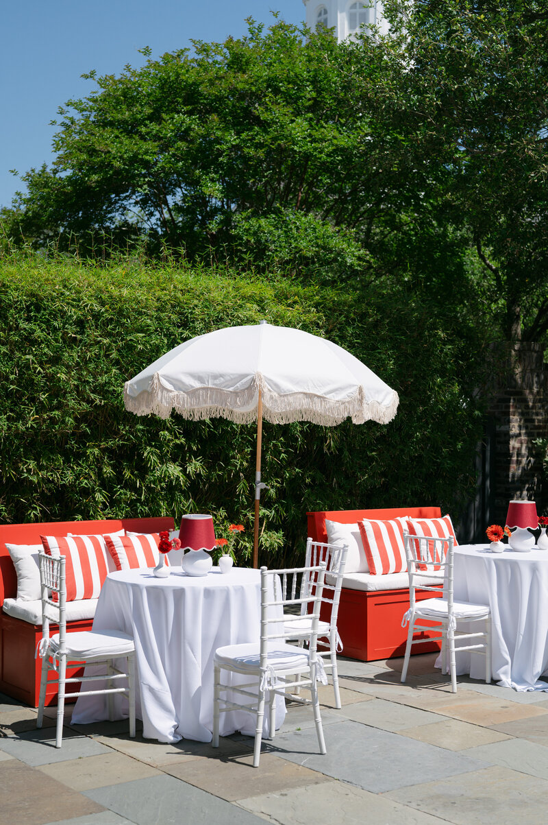 Outdoor venue with a green lawn and luxurious beach house