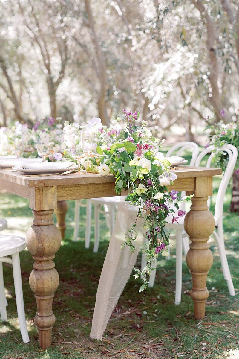 14-radiant-love-events-closeup-end-of-wooden-table-seating-of-8-middle-of-olive-tree-orchard-outdoors-romantic-elegant-timeless