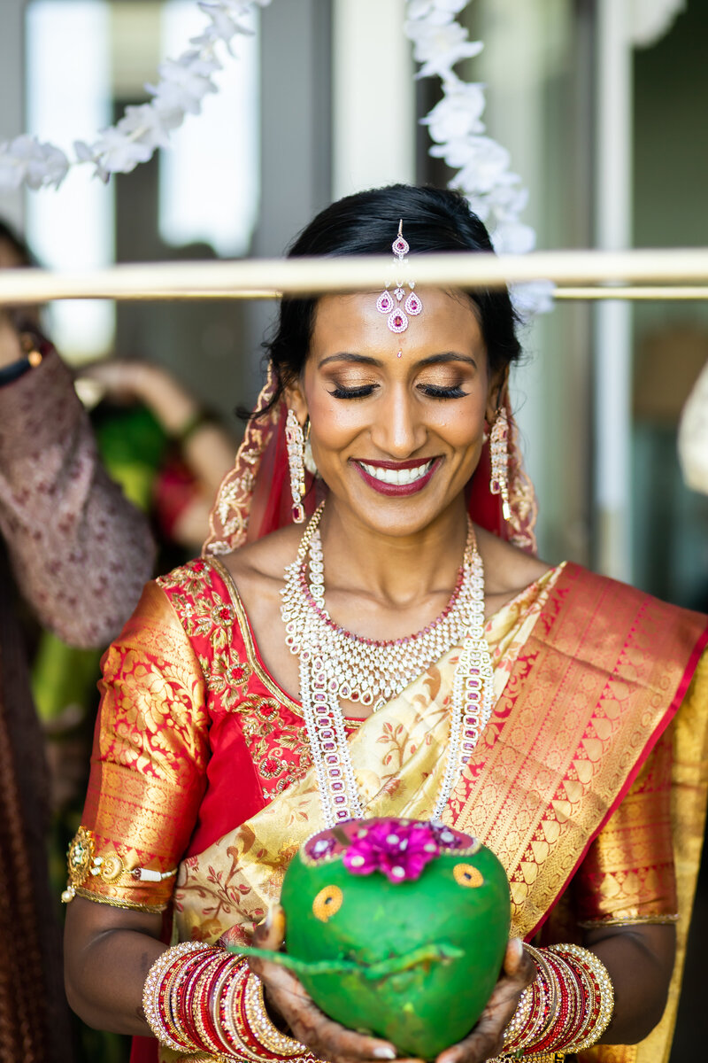 Indian Bride is adorned in colorful fabric as she walks down the aisle, Annapolis Wedding Photographer