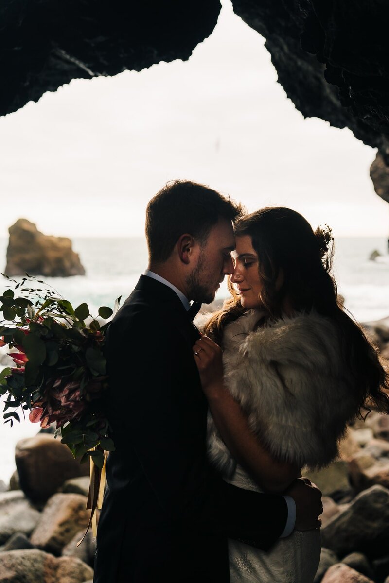 This couple cherishes an intimate moment inside a coastal cave in Iceland, surrounded by the echoes of the sea and the magic of their love.
