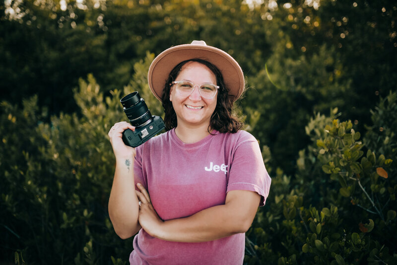 Photographer Smiling and holding camera