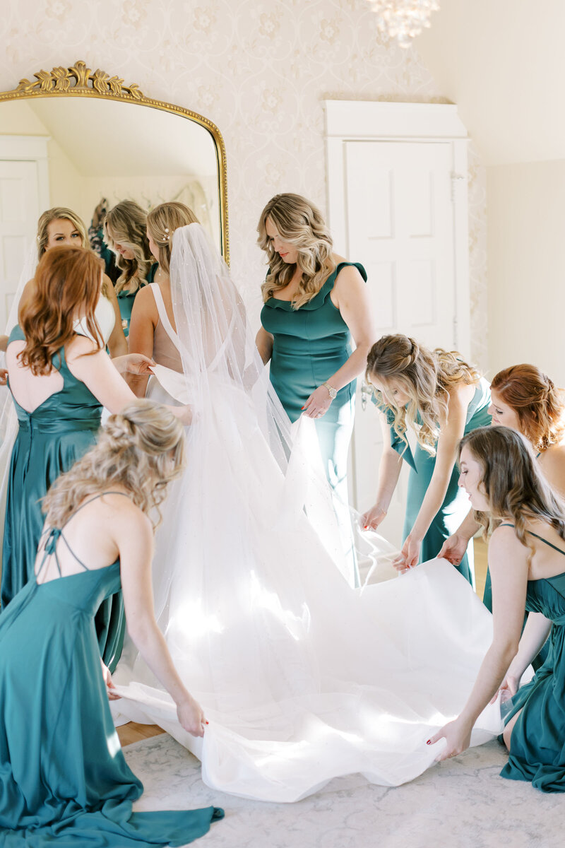 Mackenzie and her bridesmaids get ready in front of gold mirror at Venue3Two in Grand Rapids, Michigan, photography by Cynthia Mae Photography, Grand Rapids Wedding Photographer