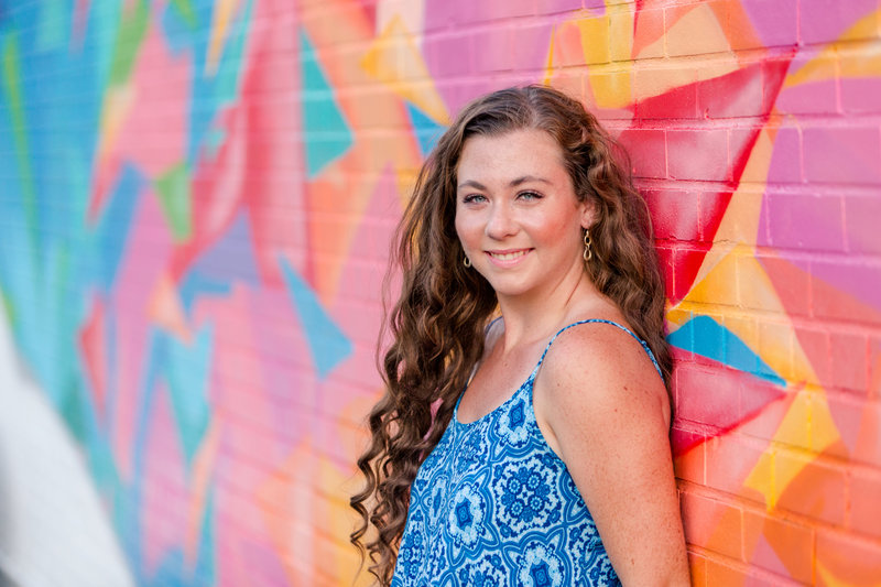 perry high school senior girl standing against a graffetii wall in canton ohio art district photographed by Jamie Lynette Photography Canton Ohio Senior photographer