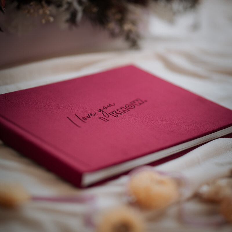 Burgundy velvet guest book with custom engraving on the cover
