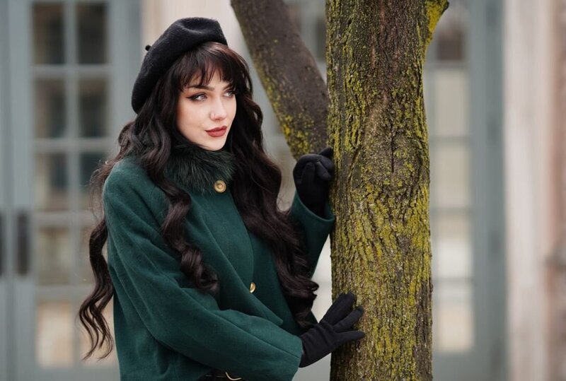 A fashion model poses elegantly against a tree, blending natural elements with high-end fashion in an outdoor setting. This image reflects the sophistication and creativity of our Commercial Videographer & Photographer services in Montreal, where we bring out the best in every subject and setting for striking, memorable visuals.