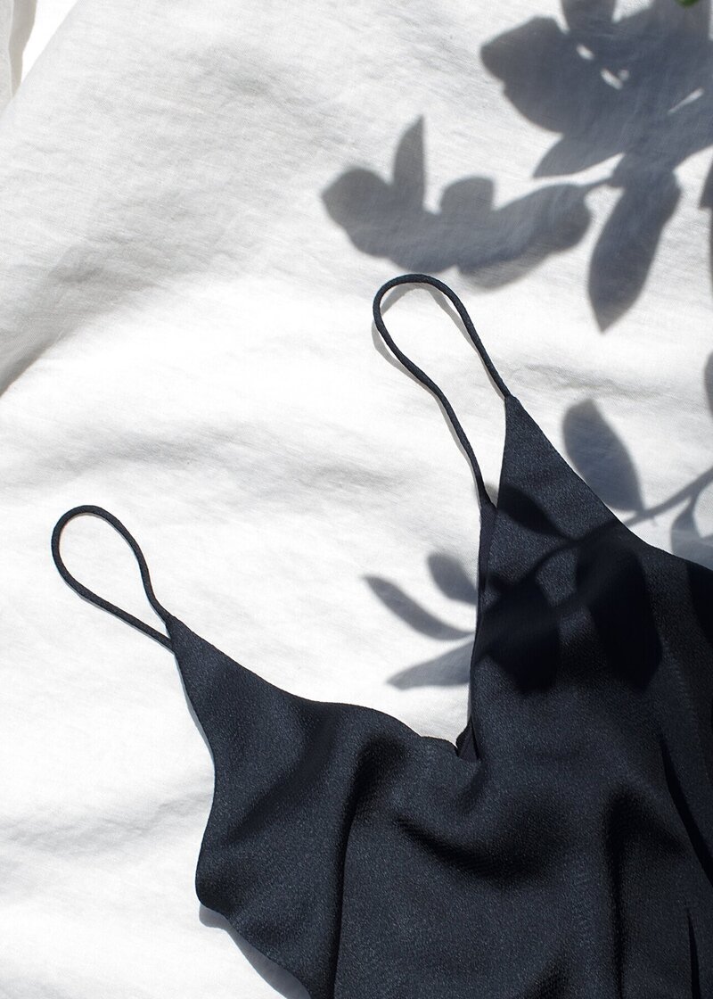 black camisole on a white bed