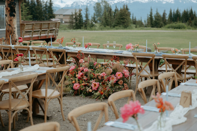 A reception table setup with pink florals.