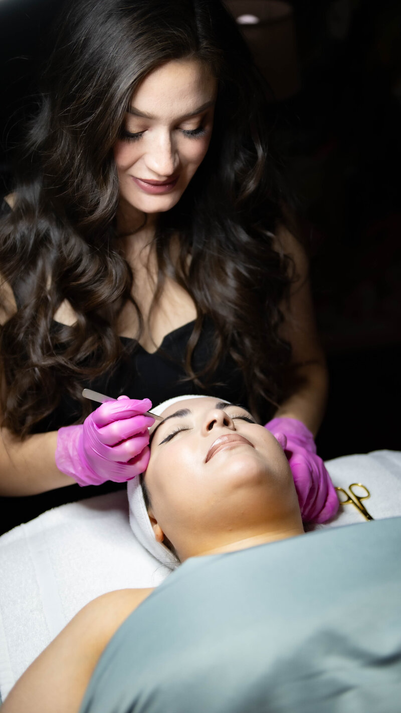 Esthetician giving an eyebrow wax in Albuquerque