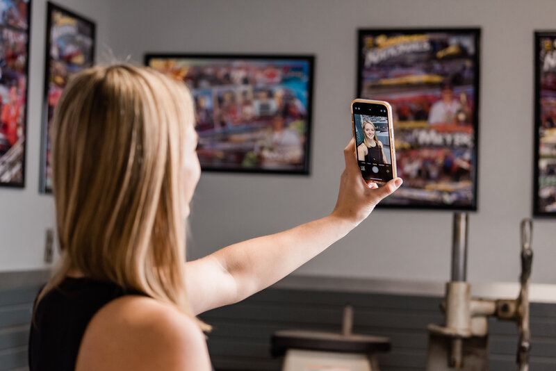 woman holding a cellphone recording a video