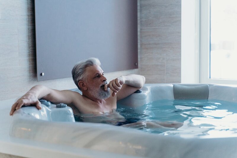 Traveler unwinding in a luxury spa jacuzzi, highlighting relaxation and self-care experiences.