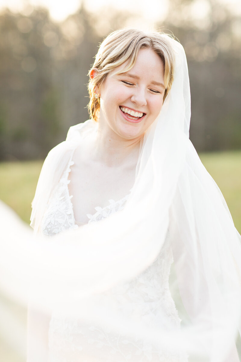 bride smiling in her wedding dress and veil