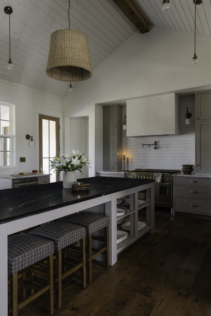 A massive custom island topped with a gorgeous bluestone piece creates space for gatherings and connecting. By Jessa Myer Interiors.