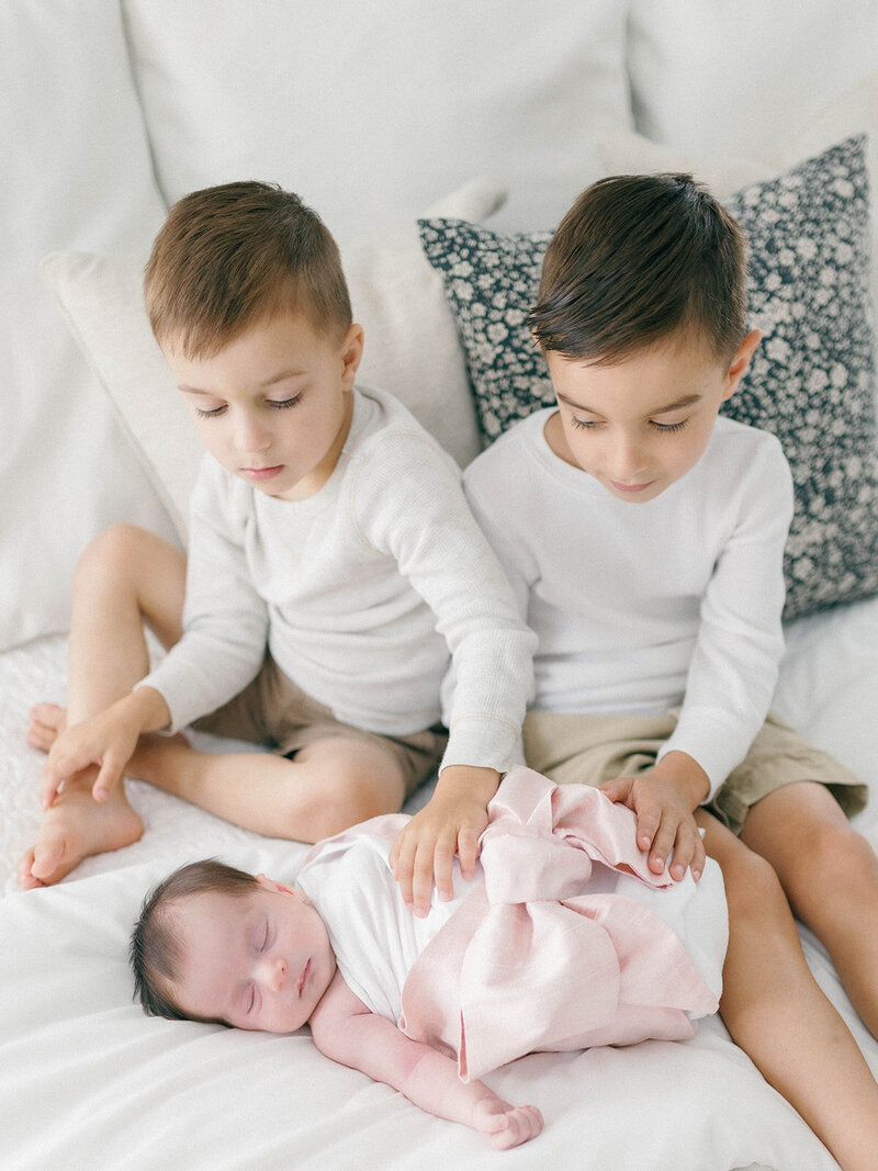 Brothers with newborn baby sister