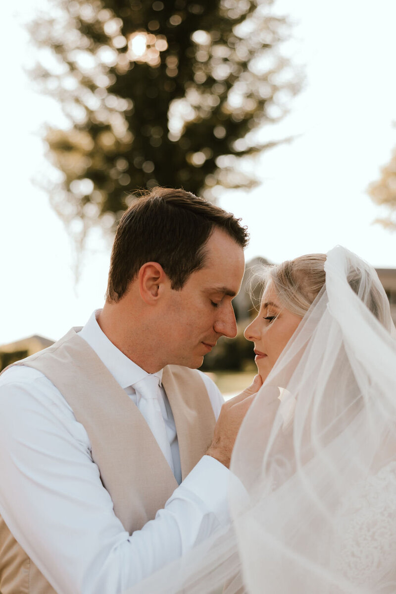 bride and groom pose for portraits on wedding day in peoria il