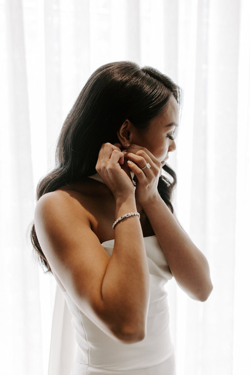 A bride puts her earrings in at The Stirling Club