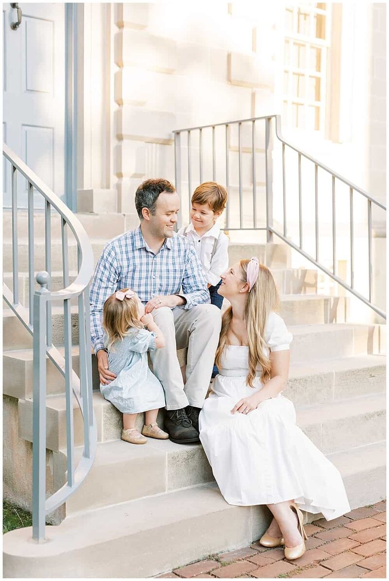 DC FFamily sits on steps at Carlyle House in Alexandria, Virginia during their Northern VA family photo session